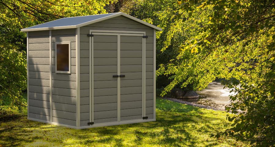 Gray storage shed with window in nature setting